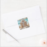 Beach Christmas Gift With Starfish Square Sticker<br><div class="desc">A beautifully wrapped Christmas gift box adorned with starfish and seashell decorations sits on a sandy beach,  with a turquoise ocean and blurred lights in the background</div>