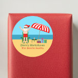 Beach Christmas Summer Santa Claus Custom Party Classic Round Sticker<br><div class="desc">This cute custom Christmas in July sticker makes perfect summer party decor for a beach bash or pool gathering. Make it a fun north pole themed extravaganza with Santa Claus in his swimming trunks next to a red and white striped beach umbrella and gifts. I've never seen Mr. Klaus in...</div>