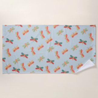 Beach towel with cheerful dragonfly pattern.
