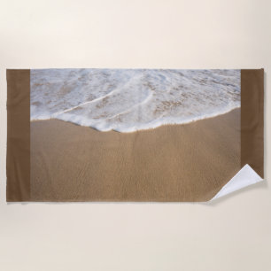 Beach towel with image of white wash on beach