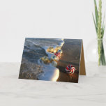 Beach with Christmas Ornaments Holiday Card<br><div class="desc">Red and gold ornaments in a beach with waves. For sunny Christmas greetings.</div>