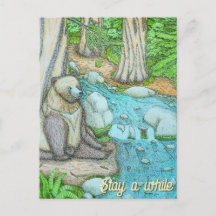 Bear sitting by a creek