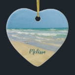 Beautiful Beach Photo Personalized Heart Christmas Ceramic Ornament<br><div class="desc">Beautiful heart shaped beach ornament with gorgeous seaside photography featuring a pretty sandpiper standing at the edge of the ocean waves on a sunny summer day. Lovely blue green water waves roll onto the sandy shore where your name is personalized in cute teal typography. A beautiful Christmas gift for a...</div>