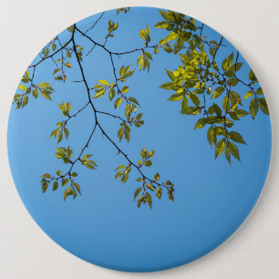 beautiful branch with green and yellow leaves hug 6 inch round button