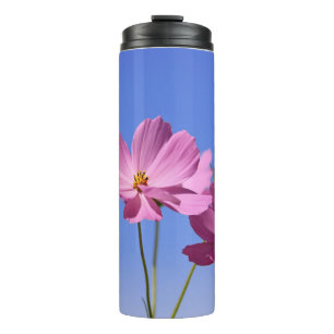 beautiful pink flowers hugging a clear blue sky thermal tumbler