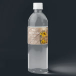 Beautiful Rustic Wood Barrel and Sunflowers Water Bottle Label<br><div class="desc">🥇AN ORIGINAL COPYRIGHT DESIGN by Donna Siegrist ONLY AVAILABLE ON ZAZZLE! Custom Wedding water bottle labels ready for you to personalize. Featured in a country barn wood setting with mason jars and string lights hanging over a bale of straw hay, a wagon wheel and beautiful yellow sunflowers. 📌If you need...</div>