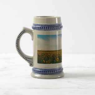 beautiful sun flowers field with cloudy blue sky a beer stein