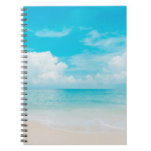Beautiful tropical beach with blue sky and white c notebook
