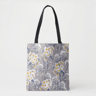 Beautiful winter flower blooming in the snow delic tote bag