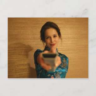Beautiful Woman holding a remote control Postcard