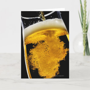 Beer been poured into glass, studio shot card