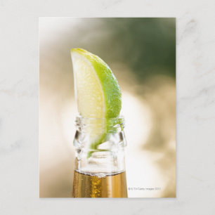 Beer bottle with lime wedge postcard