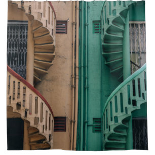 Beige and green concrete spiral stairs beside buil