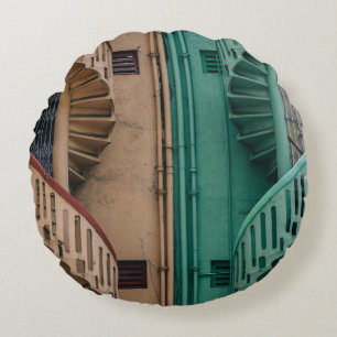 Beige and green concrete spiral stairs beside buil round pillow