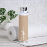 Beige Personalized Wedding Bridesmaid Water Bottle<br><div class="desc">Gift your wedding bridesmaid or maid of honour with this trendy, vacuum Insulated water bottle that features her name in white, stylized script on a beige colour background designed to match your wedding colour scheme. Personalize bottle by editing and replacing name with your own as desired. Select your water bottle...</div>