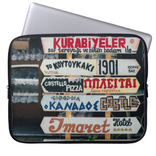 BEIGE RED AND BROWN SIGNAGES ON BEIGE STAND AT DAY LAPTOP SLEEVE