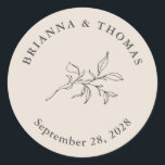 Beige Simple Botanical Wedding Classic Round Sticker<br><div class="desc">Simple and elegant with minimalist appeal, this wedding favour sticker has an autumn beige background with elegant charcoal grey text. The text template includes the Bride and Groom's names and their wedding date. A simple botanical leafy branch adds a floral element in the centre of the design. This sticker is...</div>