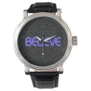 Believe text in neon lighting on brick watch
