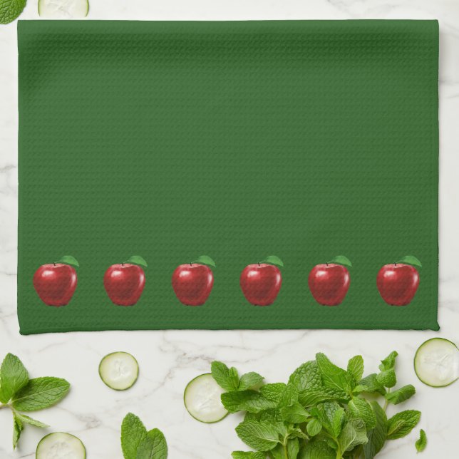 Belles pommes rouges sur serviette de cuisine vert (Plié)