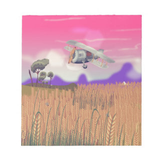 Bi-Plane Flying over crops under setting sun Notepad