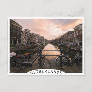 Bicycles at sunset in Amsterdam Postcard