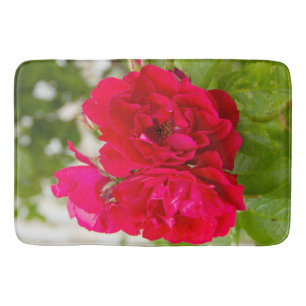 Big red roses in the garden   bath mat
