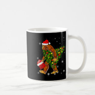 Bigfoot Carrying Christmas Tree Sasquatch Believer Coffee Mug