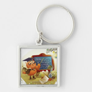 Bird holding a book and teaching at a blackboard keychain