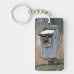 Bird, nest box with holiday wreath in winter keychain