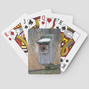Bird, nest box with holiday wreath in winter playing cards