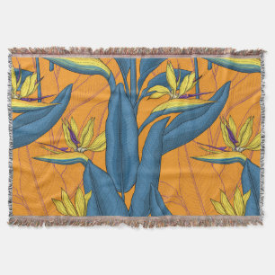 Bird of paradise flowers on orange throw blanket