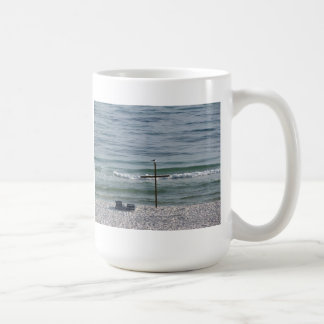 Bird on Wooden Cross by the Ocean Coffee Mug