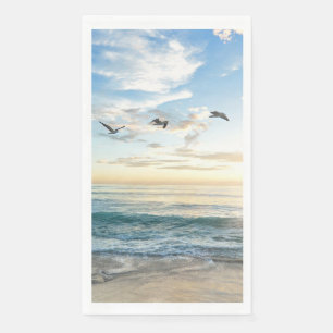 Birds in flight over the ocean napkin