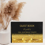 Birthday party black gold bow elegant guest book<br><div class="desc">Elegant, classic, glamorous and feminine. A faux gold colored ribbon with a bow with golden faux glitter and sparkle, a bit of bling and luxury. A guestbook for a 70th (or any age) birthday party. The name is written with golden trendy hand lettered style script. Black background. Spine: template for...</div>
