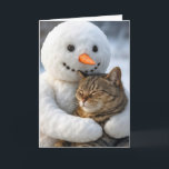 Birthday Snowman Hugging a Tabby Cat Card<br><div class="desc">A snowman with a carrot nose holds a contented tabby cat against a snowy backdrop,  where the cat has its eyes closed,  seemingly enjoying the embrace.
The inside text can be changed.</div>