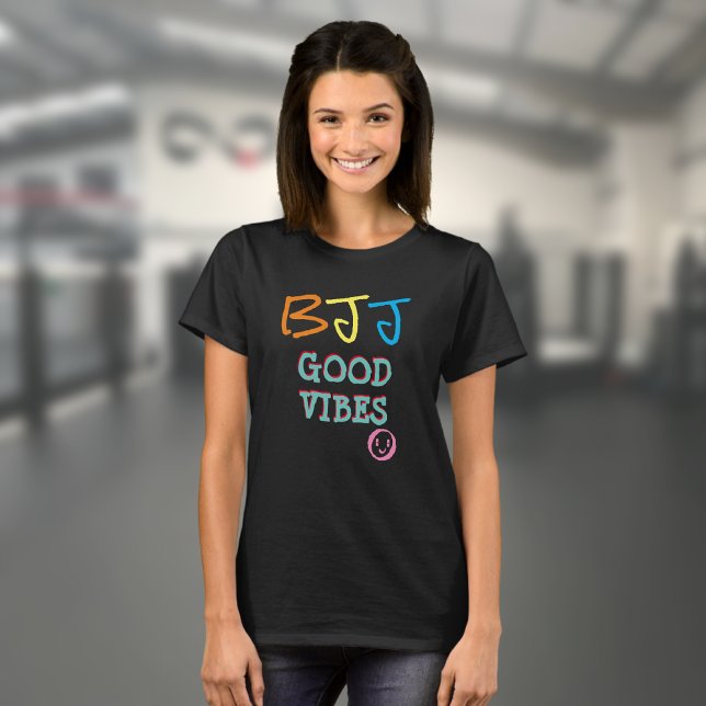 BJJ Retro Graffiti style Good Vibes Black T-Shirt (Black BJJ Good Vibes T shirt worn by a female model in a gym)