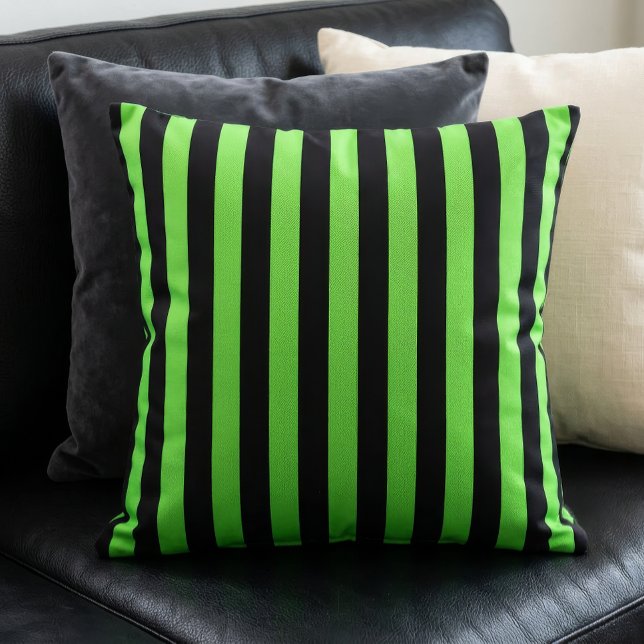 Black and Lime Green Stripes Pattern Throw Pillow (A lime green and black stripes pillow sits on a black couch in front of other pillows.)