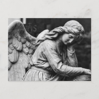 Black and white angel statue in a cemetery postcard