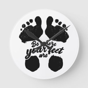 Black and White "Be Where Your Feet Are" Print Round Clock