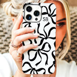 Black And White Bow Monogram iPhone 16 Pro Max Case<br><div class="desc">Dress up your phone in style with this chic and trendy black and white phone case! Featuring a playful pattern of hand-drawn bows and personalized with your monogram, this case is the perfect blend of fashion and function. Made from durable materials to protect your phone from everyday bumps and scratches....</div>