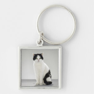 Black and white cat with glowing green eyes keychain