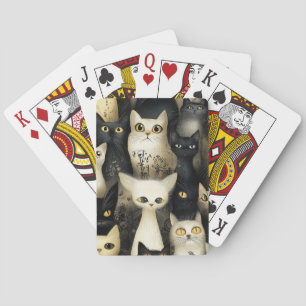 black and white cats playing cards