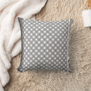 Black and white fabric design featuring intricate  throw pillow