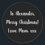 Black and White Merry Christmas from Mom gift tag<br><div class="desc">Black and White Christmas gift tag sticker with the message Merry Christmas Love Mom xxx in white typography/ script. Simply change the name Alexander to your loved one in the personalize this text box. Want to make more changes? All of the text can be personalized here as well. Or if...</div>