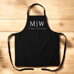 Black and White Minimalist Modern Monogram Apron<br><div class="desc">Introducing our Black and White Minimalist Modern Monogram Collection: Embrace simplicity and sophistication with our minimalist designs, curated to elevate your style effortlessly. Crafted with a keen eye for modern aesthetics, this collection features sleek black and white designs accentuated by personalized monograms. From chic stationery to versatile accessories, our collection...</div>