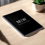 Black and White Minimalist Modern Monogram Notebook<br><div class="desc">Introducing our Black and White Minimalist Modern Monogram Collection: Embrace simplicity and sophistication with our minimalist designs, curated to elevate your style effortlessly. Crafted with a keen eye for modern aesthetics, this collection features sleek black and white designs accentuated by personalized monograms. From chic stationery to versatile accessories, our collection...</div>