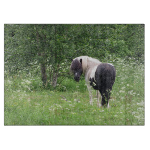 Black and White Paint Pony in Grass and Flowers Cutting Board