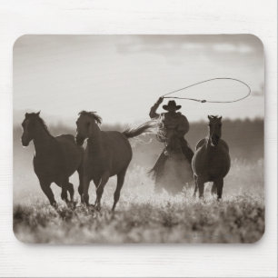 Black and White photo of a Cowboy Lassoing Horses Mouse Pad