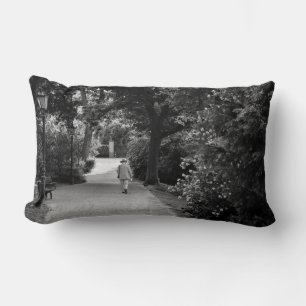 Black and white photo of old man at park lumbar pillow