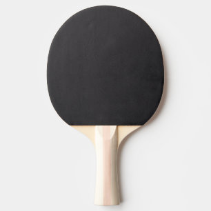 Black and white photograph of a spider and web ping pong paddle
